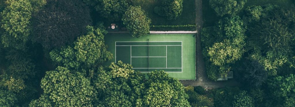 A tennis court surrounded by trees
